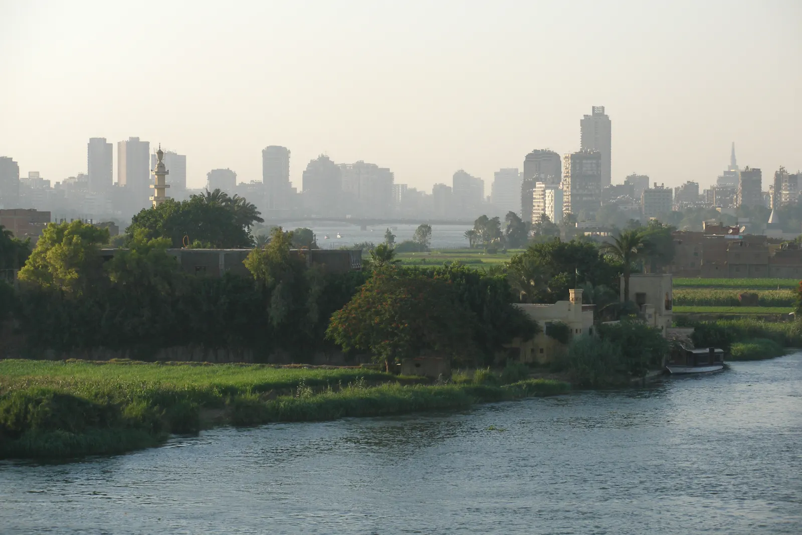 The Nile, green riverbanks and Cairo skyline through the haze