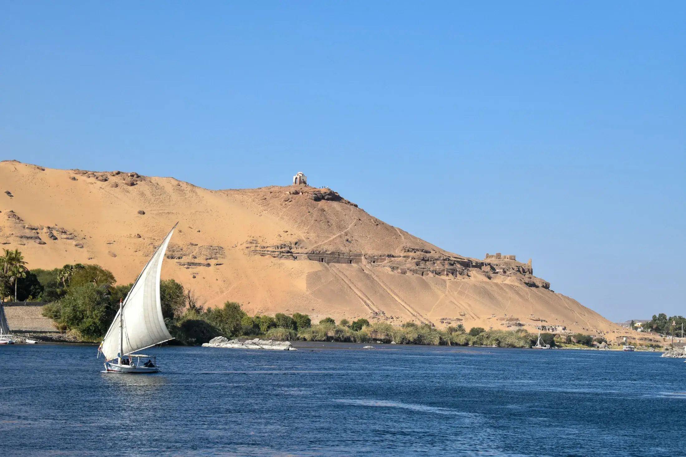 Felucca on the Nile against the hills of Aswan