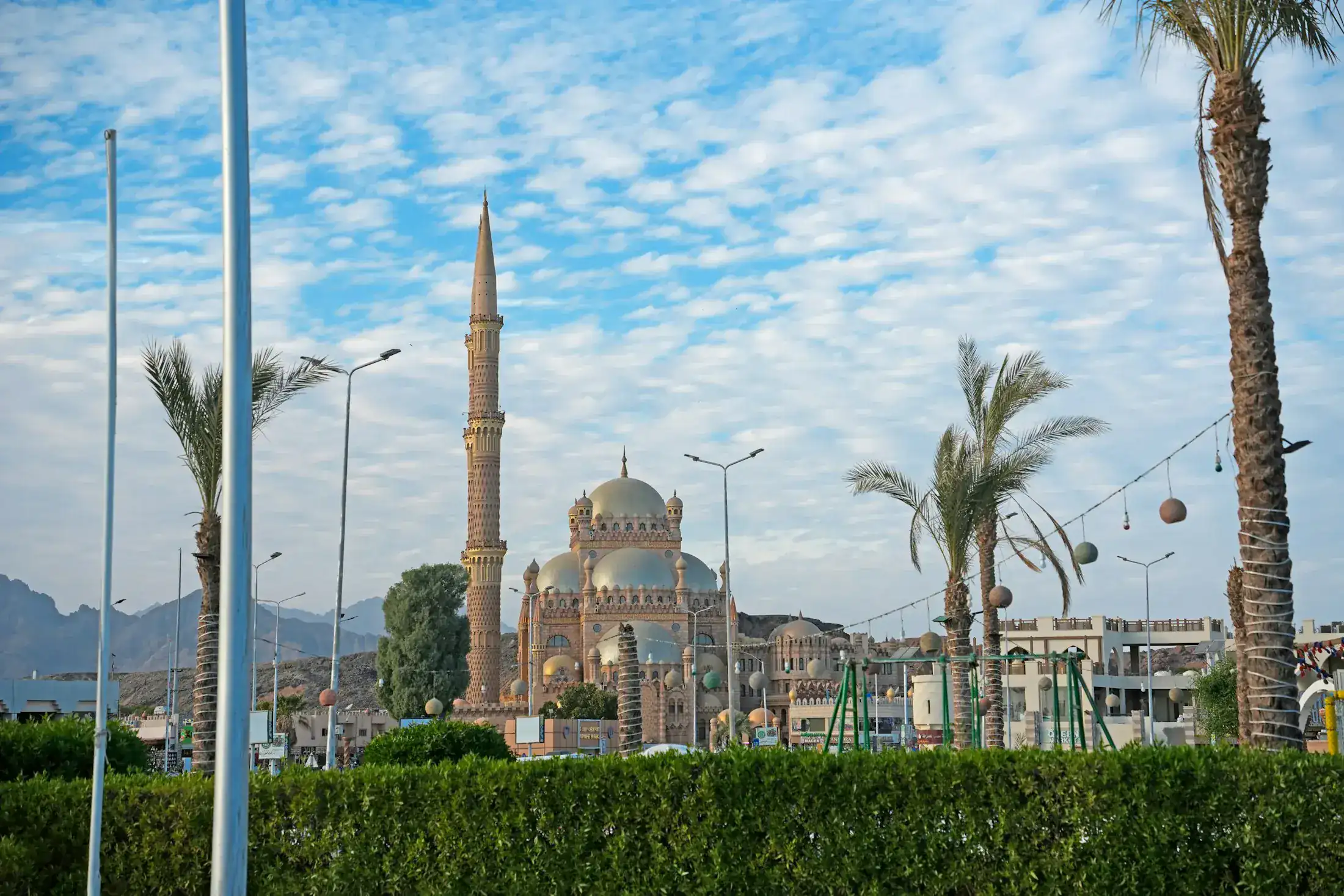 Al Sahaba Mosque among palm trees and the Sinai mountains in Sharm el-Sheikh